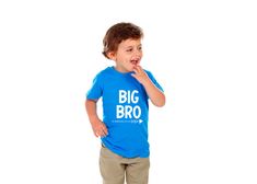 a little boy standing with his mouth open and wearing a blue t - shirt that says big bro