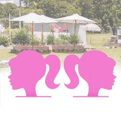 two women's heads with pink hair are in front of some trees and umbrellas