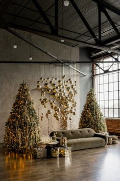 a living room filled with lots of furniture and christmas trees on top of wooden floors