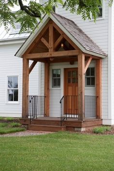 a small white house with a wooden porch