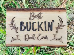 a wooden sign that says best buckin and ever on it in front of some grass