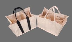 two canvas bags with handles are open on a gray background, one is white and the other is black