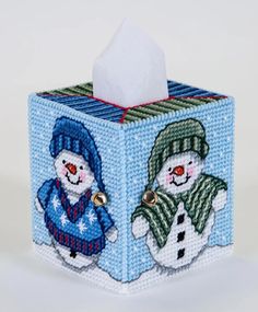 a tissue box with two snowmen on it