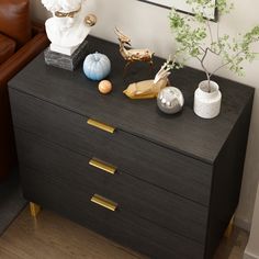 a black dresser with some decorative items on it