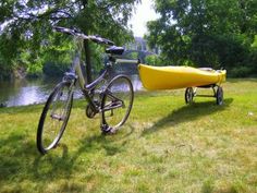 a bike parked next to a yellow kayak