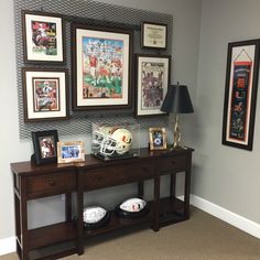 there is a football themed room with pictures on the wall and other sports related items