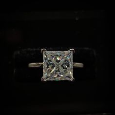 a princess cut diamond ring in the dark