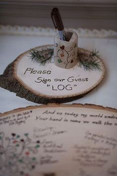 two wooden coasters with writing on them, one has a cup and pen in it