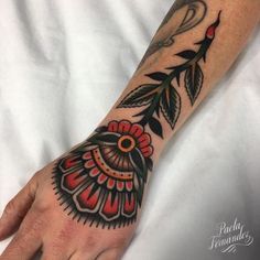 a person's hand with a tattoo on it