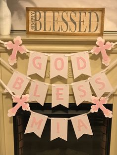 a decorated fireplace mantle with pink and white paper banner that says god's blessing mia