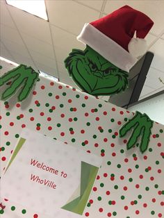 an office cubicle decorated for christmas with the grin face