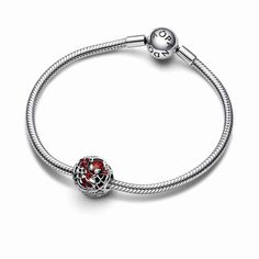 a silver bracelet with red stones on it