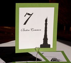 a card with the number seven on it sitting on top of a table next to envelopes