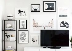 a flat screen tv sitting on top of a white entertainment center