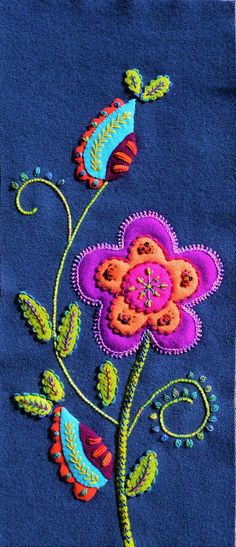 an embroidered flower on a blue background