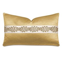 a gold and white pillow with an embroidered band on the front, along with a black border