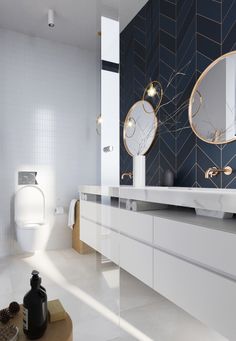 a bathroom with two sinks and mirrors on the wall