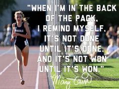 a woman running across a tennis court with a quote on it