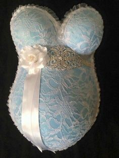 a blue bralet with white flowers on the side and a ribbon tied around it