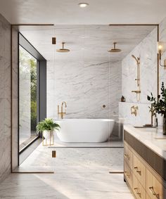 a bathroom with marble walls and flooring, gold fixtures and a large bathtub