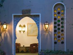 an archway leading into a living room with two lamps on either side of the doorway