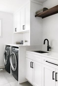 a white laundry room with washer and dryer