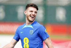 a man in blue and yellow soccer uniform smiling