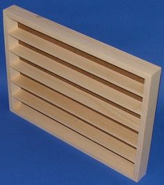 a close up of a wooden shelf on a blue background