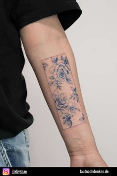 a person with a flower tattoo on their arm and the other hand is holding an object