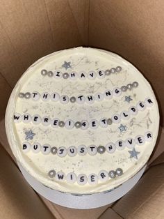 a birthday cake in a cardboard box with the words something we love written on it