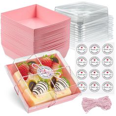 a pink box filled with lots of different types of desserts and pastries on top of each other