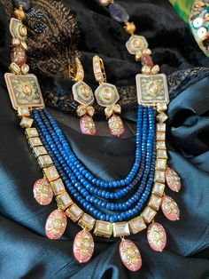 SHIVKA Special. Be Classy, Be Beautiful!! The gorgeous fusion necklace and exclusive earrings are beautifully handcrafted by our skilled Indian craftsmen from Jaipur in gold polish. Material: Blue Sapphire, Kundan,  The length of the earrings is 7 cm The drop length of the necklace is 11 inches  Necklace comes with hook closure. Notice the Tanjore artwork on cherry quartz beads, Enamelled work on side brooches Gold Fusion Jewelry Sets With Cutdana, Fusion Gold Jewelry Sets For Diwali, Multicolor 22k Gold Fusion Jewelry, Handmade Necklaces For Receptions And Festivals, Handmade Kundan Jewelry Sets, Handmade Elegant Kundan Jewelry Sets, Elegant Handmade Kundan Jewelry Sets, Gold Cutdana Fusion Necklace, Handmade Chandbali Jewelry For Formal Events