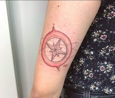 a woman with a compass tattoo on her arm