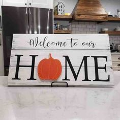 a wooden sign that says welcome to our home with a pumpkin on the front and back