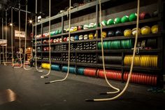 there are many different colored ropes in the room with no one around them on the shelves