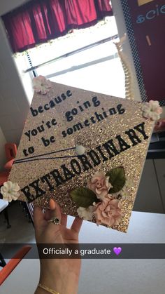 someone holding up a graduation cap that says, because you're going to be something extraordinary