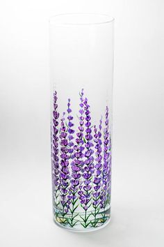 a glass with purple flowers painted on it