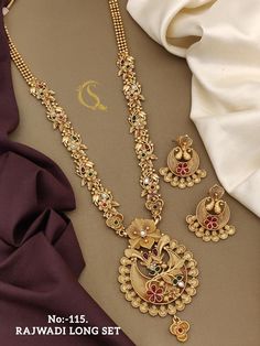 Description :- Antique Gold Plated Long Pendant Necklace & Drop Earring Indian Jewelry Set | Gold Pendant Necklace | Gift For Her Gift yourself a royal look with this perfectly crafted kundan necklace set from Manalisstudio. Crafted with high quality kundan stones and pearls, it is impressive in design. The green enamel artwork adds perfect texture to the design. Perfect for weddings and festivities, this antique necklace set should be put on with your favorite sari or lehenga. 100% Satisfaction Antique Gold Locket, Red Necklace Set, Indian Gold Necklace Designs, Indian Jewelry Set, Earring Indian, Jewelry Set Gold, Necklace Set Gold