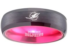 a black and pink ring with the miami dolphins logo on it's center band