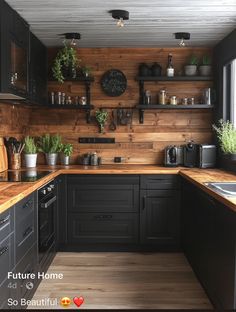 a kitchen with black cabinets and wooden counter tops