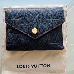 Used Louis Vuitton Victorine Wallet In Supple Monogram Empreinte Leather In Navy. This Item Has Been Used But In Very Good Condition. Very Clean Inside. The Only Issue Is A Mall Lift In The Glazing On One Of The Bends.(See Pic 6) Comes With Dust Bag. The Bends, Used Louis Vuitton, 7 H, Louis Vuitton Bag, Dust Bag, Bag Lady, Louis Vuitton, Monogram, Wallet