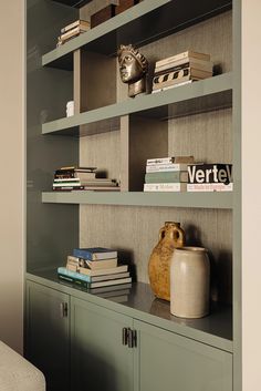 a book shelf with books and vase on it