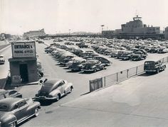 an old black and white photo of a parking lot full of cars