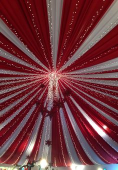 a large red and white tent with lights on it