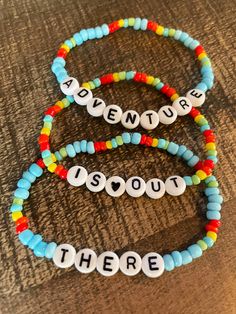 three beaded bracelets that say adventure, i love you there