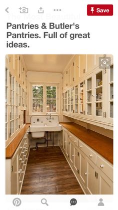 a kitchen with white cabinets and wood flooring next to a sink in front of a window