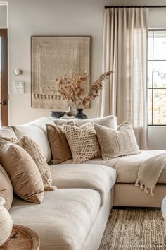 a living room filled with furniture and pillows