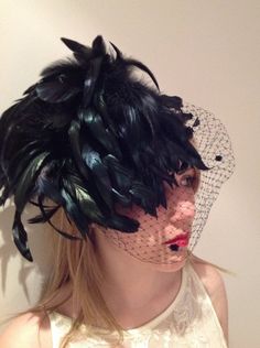 Black Fascinator- 1950's Retro- Classic Headpiece- Wedding Headpiece- Wedding Birdcage- Steampunk- Feather- Derby Hello, This black fascinator has a birdcage veil that can be worn over the face or pulled up and put under the feathers. It's perfect for a wedding or black tie event. The black feathers have an irridence to them. It is on a matching stainless steel headband that is wrapped with ribbon. Also, adjustable and very comfortable. Plus, there is no hat hair! Net comes with or without dots. Vintage Black Fascinator For Costume Party, Black Feather Trim Headpiece For Evening, Black Feathered Headpiece For Evening, Vintage Black Fascinator For Wedding, Black Feathered Wedding Costume Hat, Black Feathered Costume Hat For Wedding, Vintage Evening Fascinator With Feathers, Black Headpiece With Feather Trim For Evening, Vintage Mini Hats With Feathers For Party