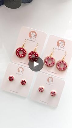 three pairs of earrings with red and white polka dots on them, sitting next to each other