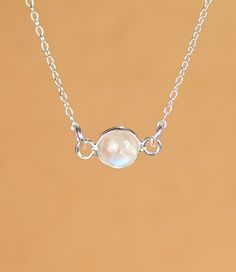 Moonstone necklace - silver moonstone - june birthstone - rainbow moonstone - a silver bezel set moonstone on a sterling silver chain A beautiful, one of a kind, silver lined rainbow moonstone, hanging horizontally from a 16 inch sterling silver chain. Please feel free to select a different length chain if you prefer! I took multiple photos in different light to show all the possible colors of this gem. Moonstones reflect at different angles and all sorts of light. Need a few reasons to love a m White Sterling Silver Necklace With Moon Charm, Minimalist White Gemstone Birthstone Necklace, White Moonstone Necklace With Delicate Chain, Minimalist Silver Birthstone Necklace With Adjustable Chain, Dainty White Moon Phase Necklaces, Dainty White Round Birthstone Necklace, Minimalist White Birthstone Necklace, Dainty Sterling Silver Birthstone Necklace With Bezel Setting, Dainty White Moonstone Necklace